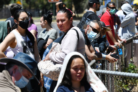 Adelaide residents queue for a coronavirus test at Parafield Gardens in Adelaide on Tuesday.