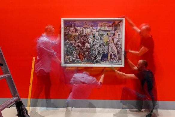 Toby Pola and Chris Maxwell, NGV Installers with Pablo Picasso’s Abduction of the Sabines.