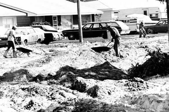 esidents of Moses Lake, Wash., shovel large deposits of volcanic ash that were dumped on the city from the Mount St. Helens eruption, in this May 24, 1980, file photo.