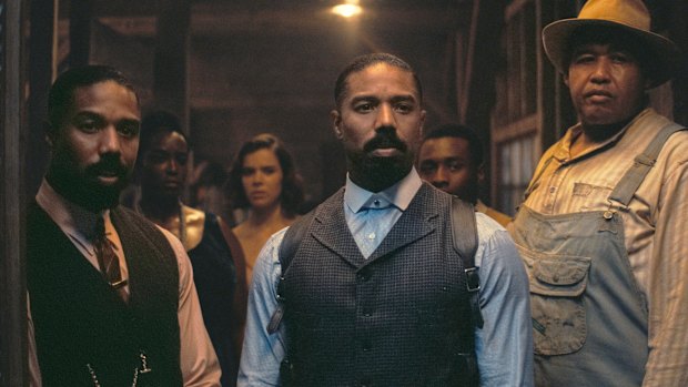 Michael B. Jordan and Michael B. Jordan (playing identical twins) and Omar Benson Miller in Sinners.