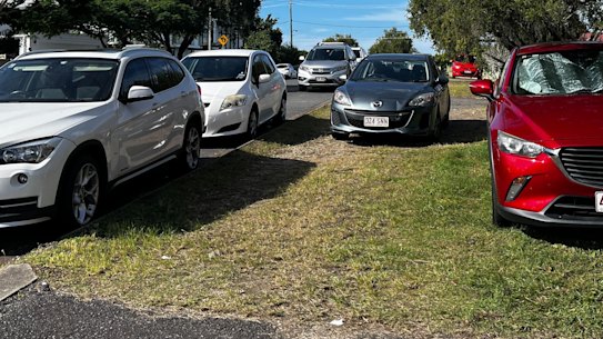 Cars parked on the footpath and kerb at Norman Park.