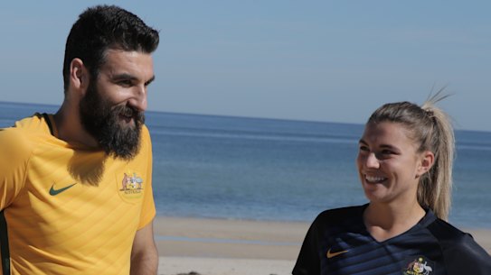 Former Socceroos captain Mile Jedinak with Matildas stars Lisa De Vanna and Steph Catley.