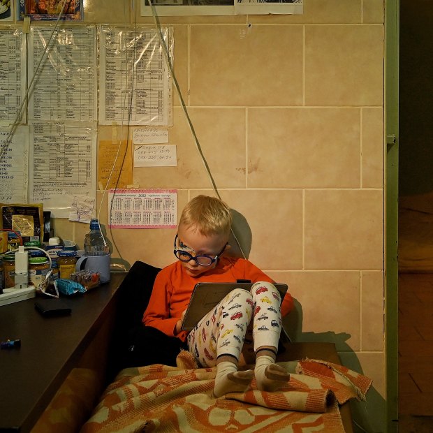 In the Kharkiv No 4 Emergency Hospital, three-year-old Viktor Baklanov sits in the basement, where he is sheltering with his father while his wounded brother Volodymyr is treated in one of the trauma wards. 