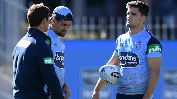 Half your luck: Nathan Cleary, right, speaks with Andrew Johns and Cody Walker at Blues training.