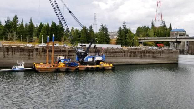 The US Army Corps of Engineers works on the Bonneville Dam on the Columbia River that connects Oregon and Washington.