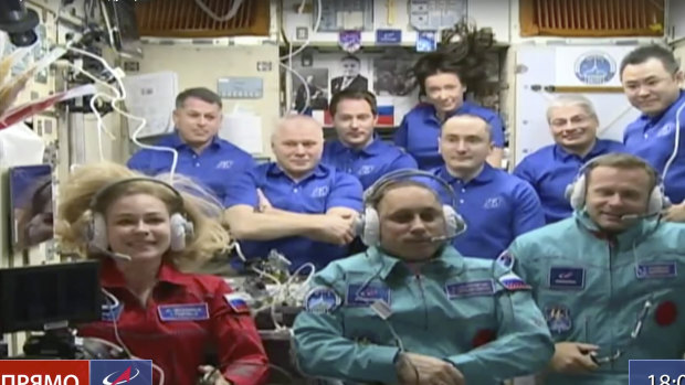 All aboard: actress Yulia Peresild, left, film director Klim Shipenko, right, and cosmonaut Anton Shkaplerov sit in the first row among other participants of the mission in the International Space Station.