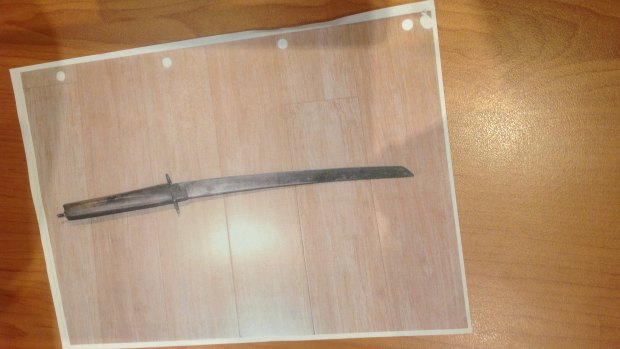The sword police allege Stephen Macras held up at officers.