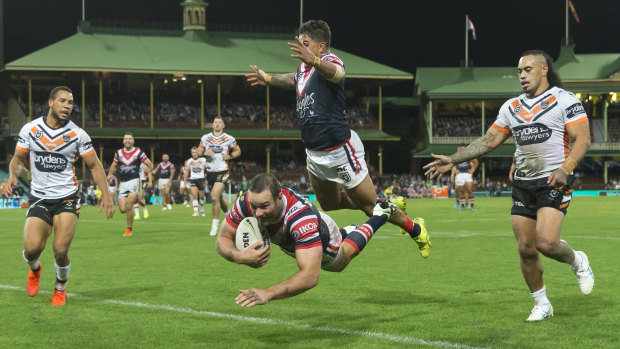 Airborne: Boyd Cordner crosses for the Roosters as Latrell Mitchell gets out of his way.