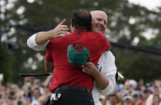 Tiger Woods hugs Joe LaCava after sinking his final putt on the 18th.