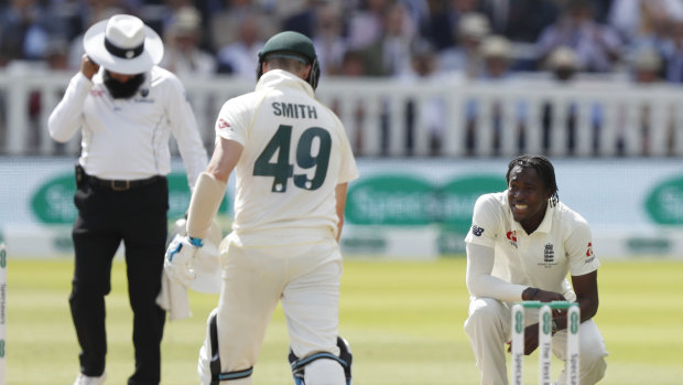 Express man: Jofra Archer looks up at Steve Smith before felling the Australian later on day four with a bouncer.