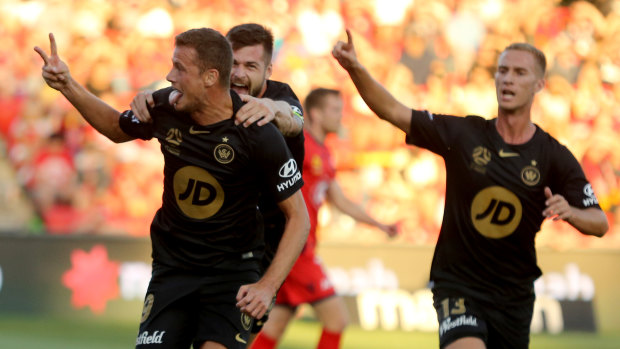 Springing and upset: Oriol Riera celebrates opening the scoring with Brendan Hamill and Tass Mourdoukoutas. 