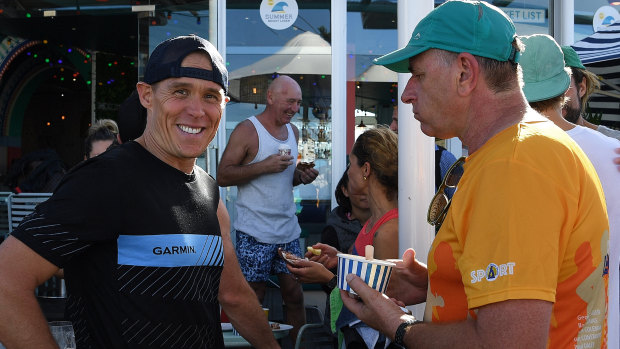 Bondi lifeguard Andrew Reid, left, talks with Chris Edwards, who has run the race every single year since 1971, during a breakfast at Bondi Beach to announce the opening of entries for the 2019 City2Surf.