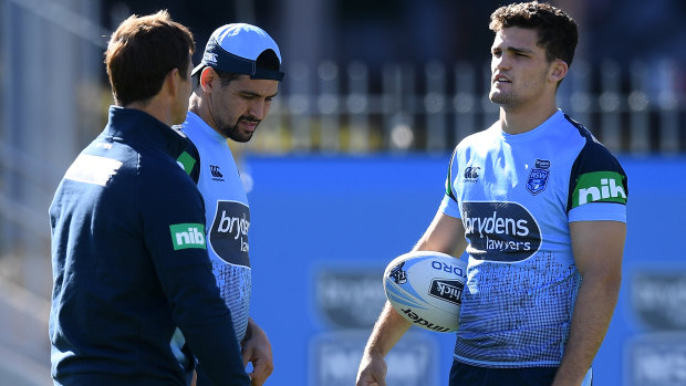 Half your luck: Nathan Cleary, right, speaks with Andrew Johns and Cody Walker at Blues training.