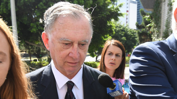 Former priest Michael Endicott (centre) arrives at the District Court in Brisbane on Monday for his sentencing hearing.