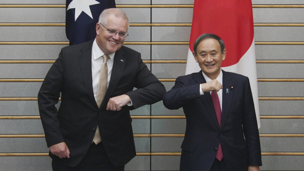 Australian Prime Minister Scott Morrison poses with Japanese Prime Minister Yoshihide Suga at the start of their meeting at Suga's official residence in Tokyo.
