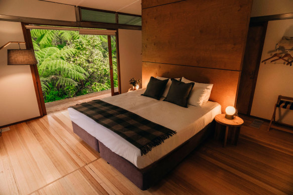 Inside a guest room, with its sliding doors opening to the bush.