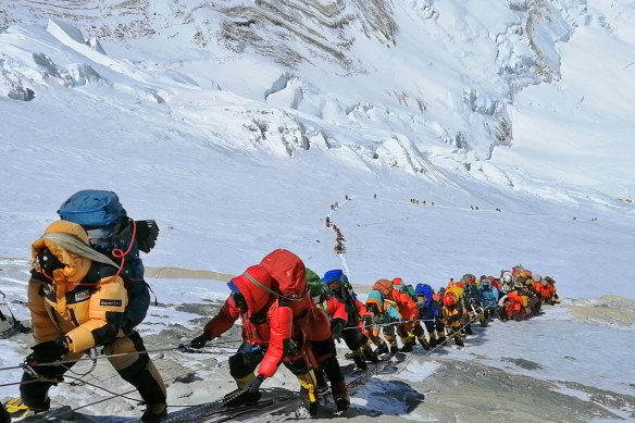 A long queue of mountain climbers lines one of the two popular routes on Mount Everest in May 2019. 