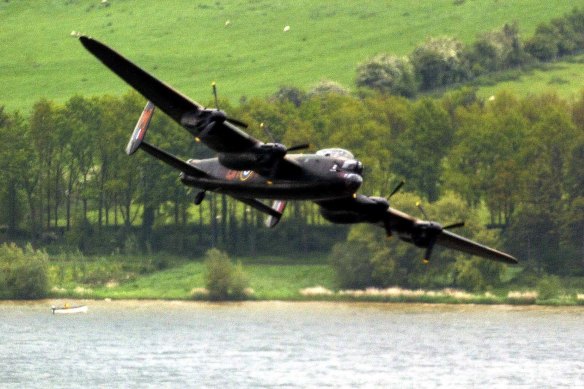 A Lancaster bomber swoops over Eyebrook Reservoir in central England, May 17, 2003 to mark the 60th anniversary of the Dambuster raid.  