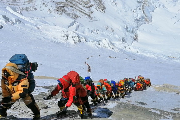  A long queue of mountain climbers line one of the two popular routes on Mount Everest in May 2019. 