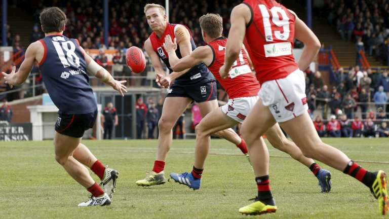 Bernie Vince handballs under pressure.