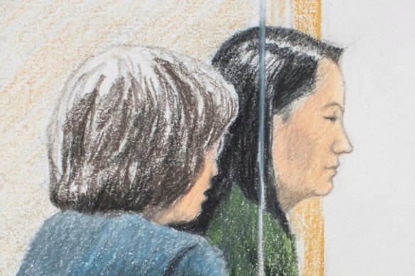 Meng Wanzhou, right, sits beside a translator during a bail hearing at British Columbia Supreme Court in Vancouver, on Friday.