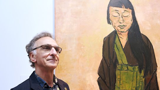 Tony Costa with his 2019 Archibald Prize-winning portrait of artist Lindy Lee.