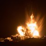 Smoke and fire rise to the sky following an Israeli airstrike in the northern Gaza Strip, as seen from southern Israel, on Thursday.