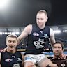 Sam Docherty of the Blues is chaired from the field after his final game by Patrick Cripps of the Blues (left) and Kade Simpson.