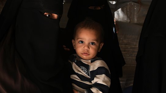 Australian Zahra Ahmed (left) holding her son Ibrahim in al Hawl camp in north-east Syria in October 2019. 