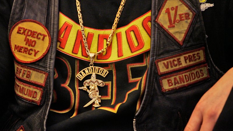 Bandidos bikie gang president charged with blackmail after cash found at his home