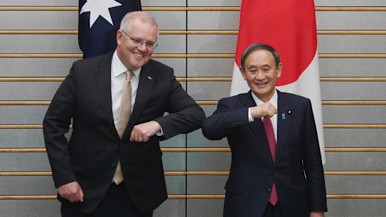 Australian Prime Minister Scott Morrison, left, poses with Japanese Prime Minister Yoshihide Suga at the start of their meeting at Suga's official residence in Tokyo Tuesday, Nov. 17, 2020. Morrison is in Japan to hold talks with his Japanese counterpart, Yoshihide Suga, to bolster defense ties between the two U.S. allies to counter China’s growing assertiveness in the Asia-Pacific region. (AP Photo/Eugene Hoshiko, Pool)