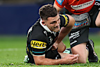 Nathan Cleary is attended to by a trainer. 