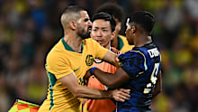 Aziz Behich pushes Endrick.