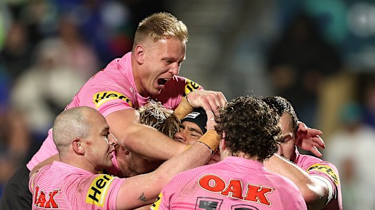 The Panthers celebrate a try against the Warriors on Saturday.