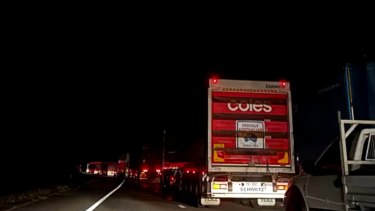 A crime scene on the Logan Motorway had trucks and cars waiting hours to pass through after a man was struck by a vehicle. Photo: Nine News, Twitter
