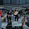 The Beatles perform on the roof in 1969.