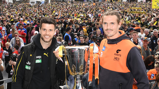 Trent Cotchin and Phil Davis with the Premiership Trophy during the 2019 AFL grand final parade in Melbourne.