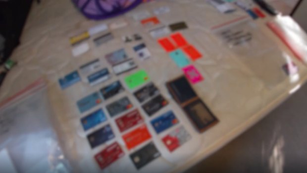 Police found numerous bank cards and identity photos during their search.