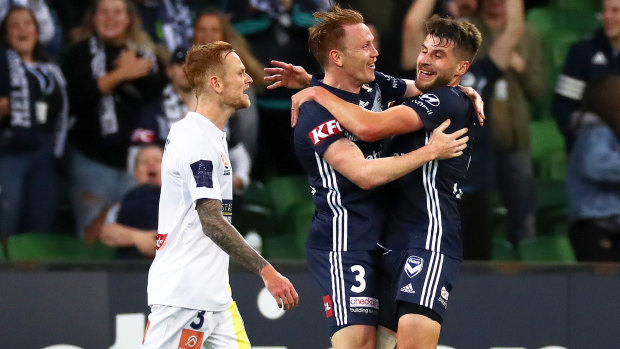 On target: Victory's Corey Brown (centre) celebrates with team mate Terry Antonis (right) after scoring a goal as Jack Clisby of the Mariners looks on during the round 4 match at AAMI Park in Melbourne.