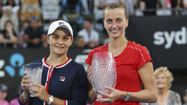 Glassware: Kvitova holds the winner's trophy alongside runner-up Barty and her consolation prize.