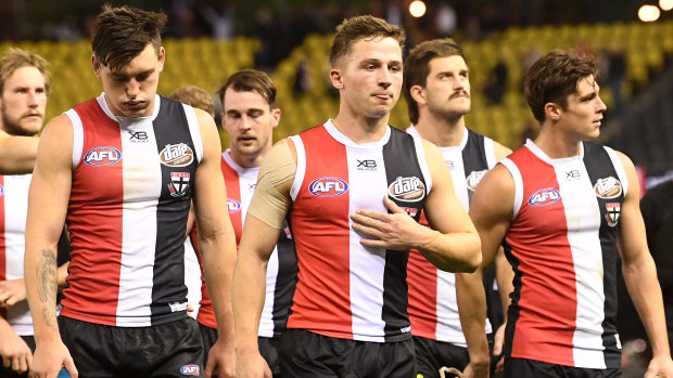 Despondent St Kilda players leave the field after another defeat.