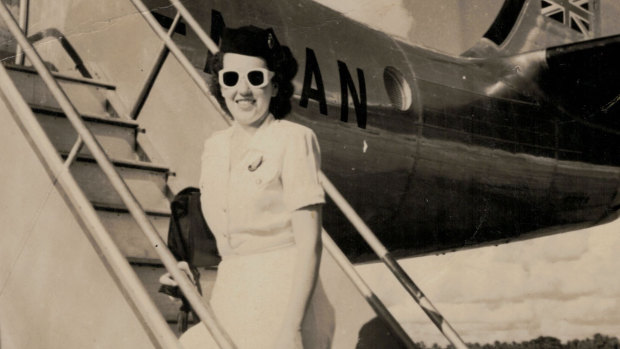 Qantas hostess Patricia Burke arrives for work in summer uniform, 1948.