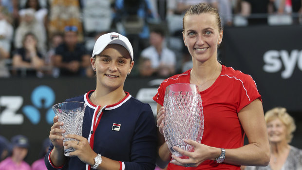 Petra Kvitova holds the Sydney International winner's trophy alongside runner-up Ash Barty and her consolation prize.
