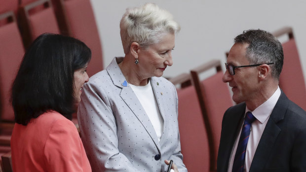 Crossbench MPs Julia Banks and Kerryn Phelps shake hands with Greens leader Richard Di Natale after the Senate agreed on House's amendments to its amendments to the Home Affairs Legislation Amendment Bill.