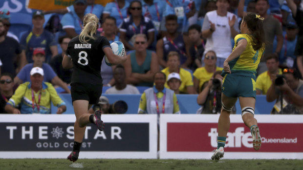 The clincher: Kelly Brazier runs away from Australia's Dom Du Toit to score the match-winning try in extra time of the women's sevens final.