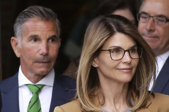 Lori Loughlin (right) and husband Mossimo Giannulli (left) depart a federal court.