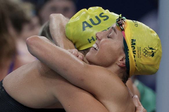 Meg Harris and Emma McKeon embrace after winning gold in the 4x100m freestyle relay. 