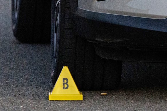 A bullet casing lies on the road outside the Merrylands West home. 