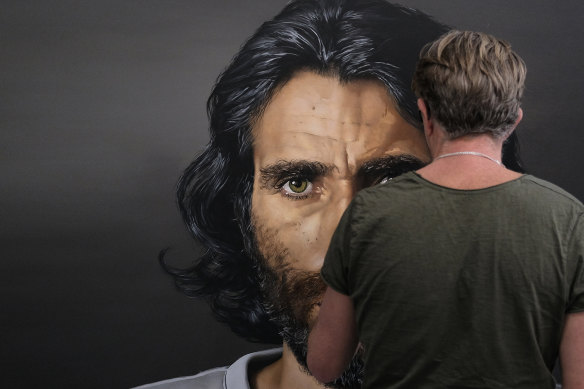 Archibald Prize finalist Angus McDonald with Behrouz Boochani’s Resistance, which he says is a portrait of the refugee's unshakeable resolve. 
