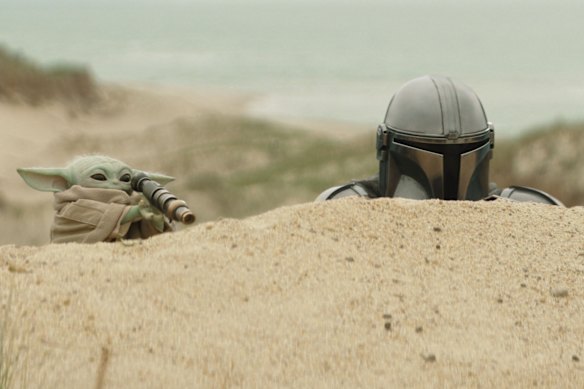 A masked Pedro Pascal with Grogu in the film.